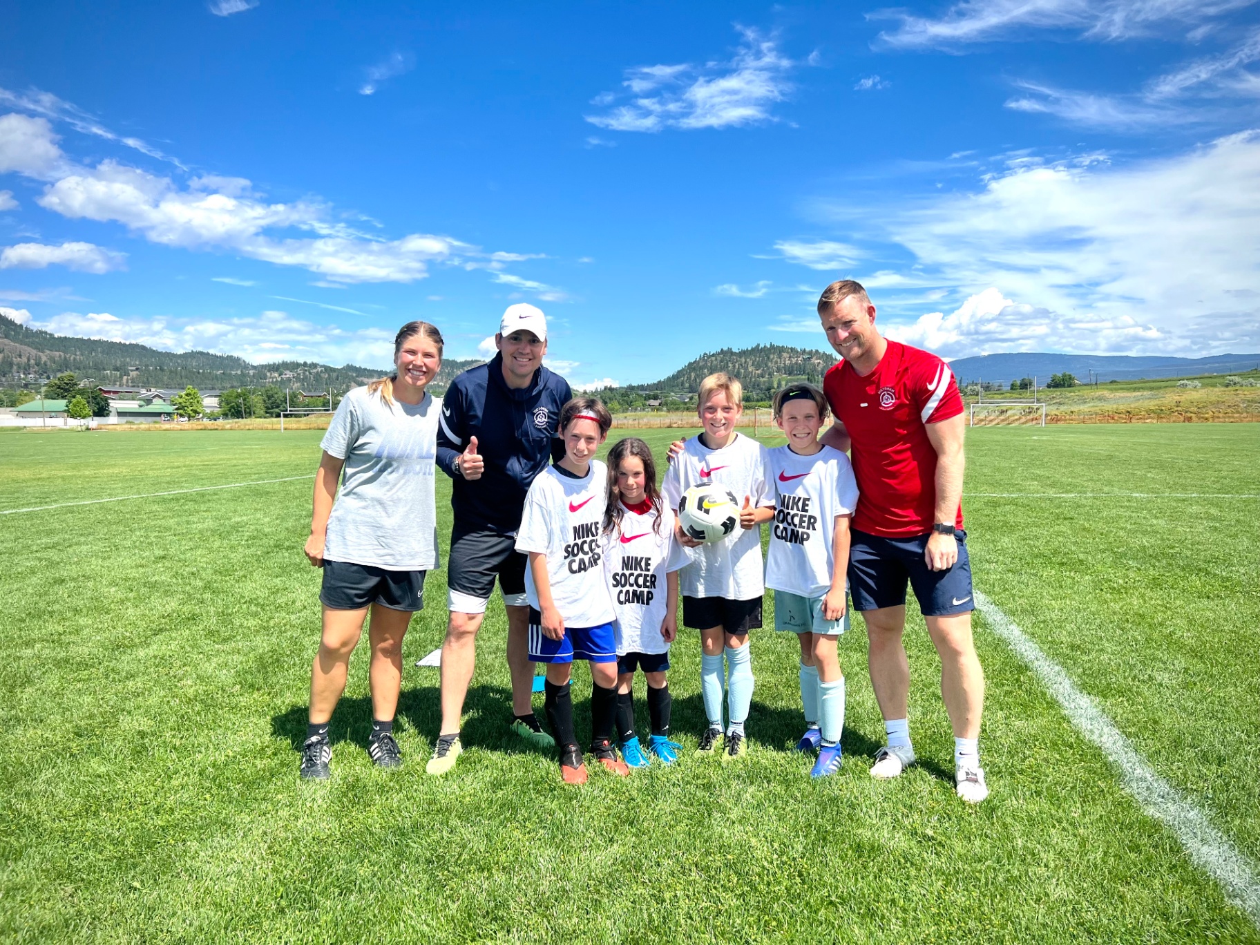 Victorem coaches with young players after a session